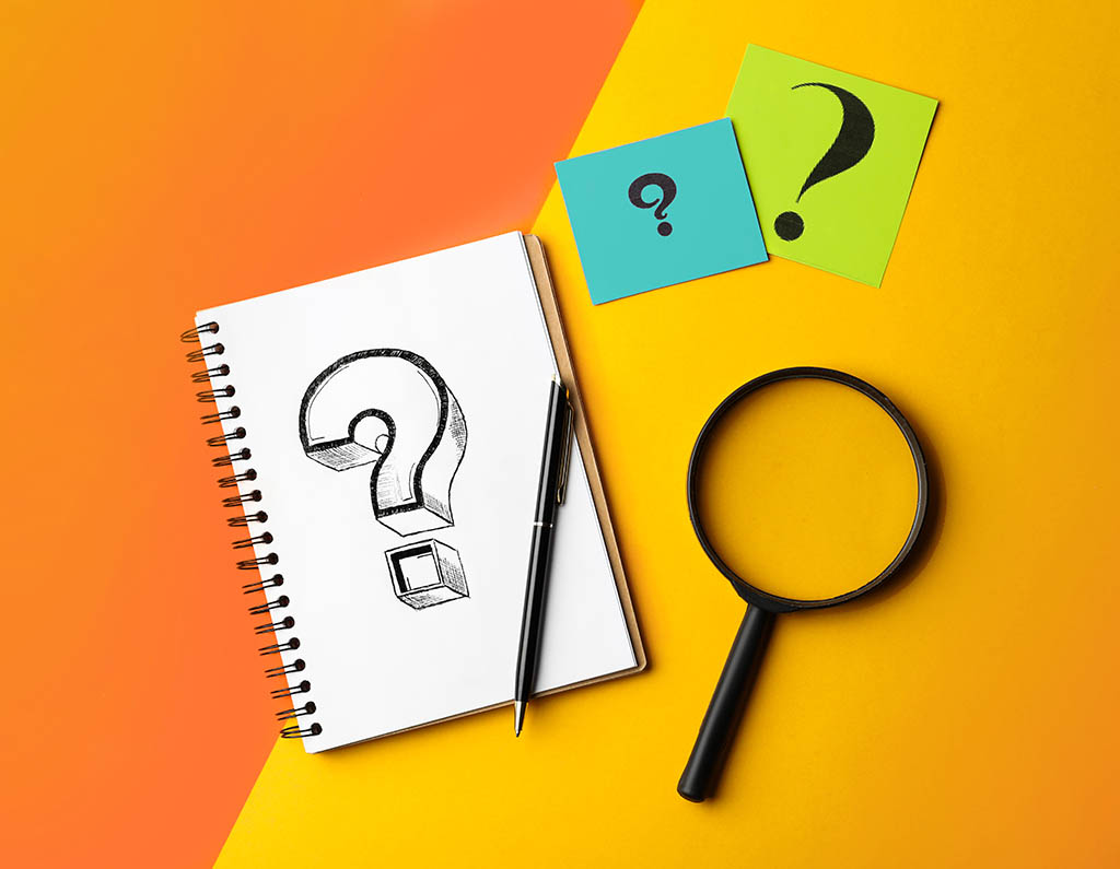 Flat lay composition of notebook, magnifier glass and cards with question marks on color background