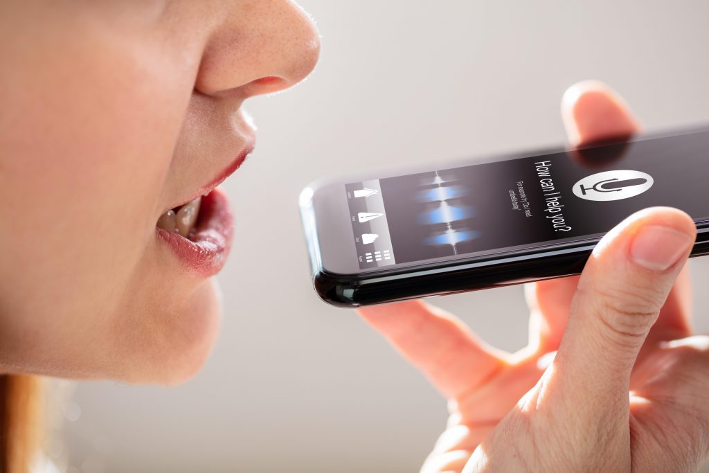 Woman using voice search on mobile phone