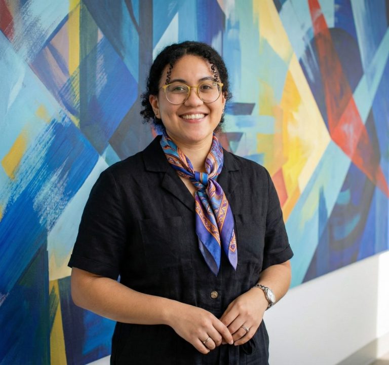 Zoe Boitel in front of mural